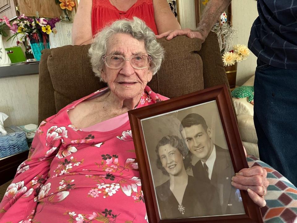 Sarah McSweeney holds a picture of herself and her late husband, Verlin.