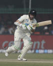 New Zealand's Tom Latham plays a shot during the day three of their first test cricket match with India in Kanpur, India, Saturday, Nov. 27, 2021. (AP Photo/Altaf Qadri)