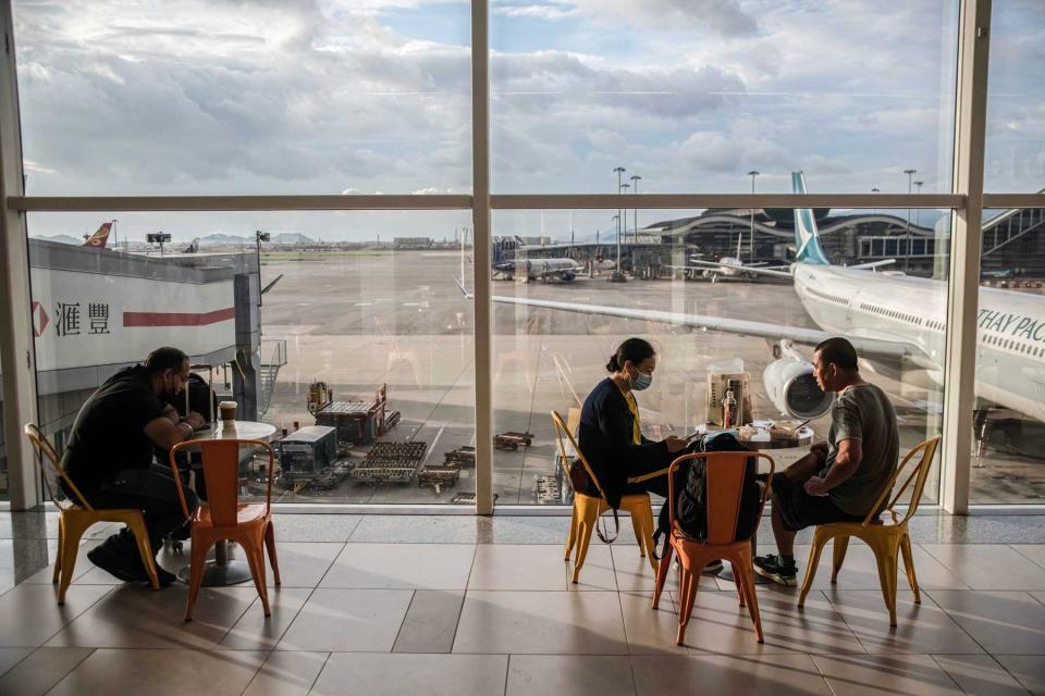 Passengers enjoy their meals at the departure hall of Hong Kong International Airport