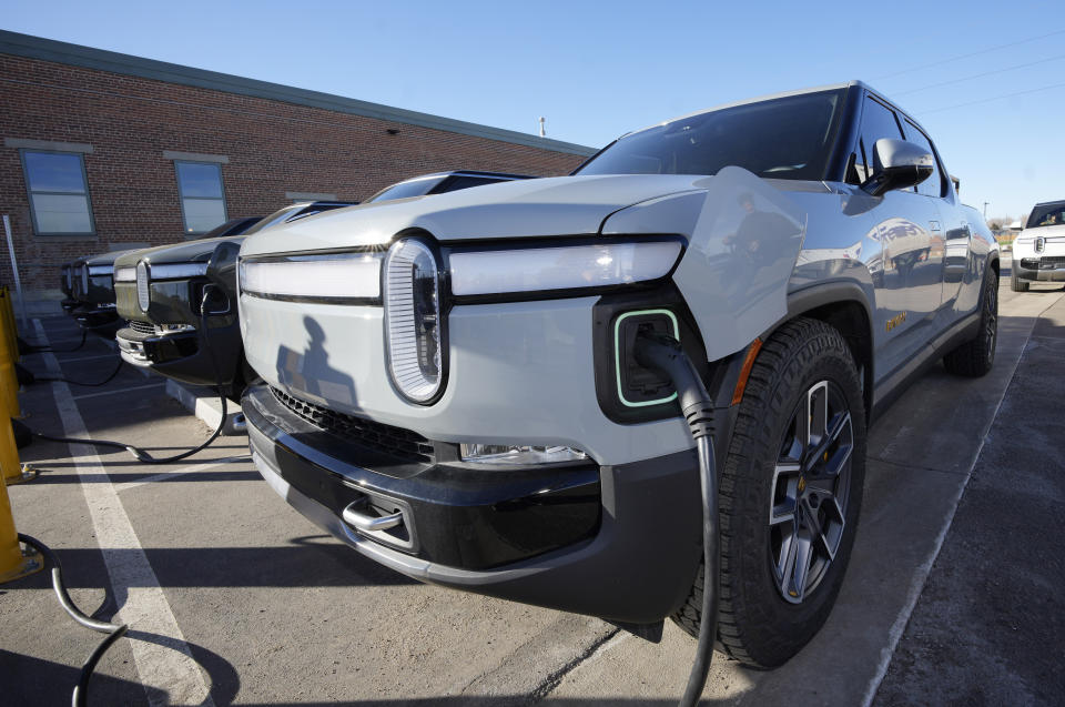 File - A 2023 R1T pickup truck is charged in a bay at a Rivian delivery and service center Wednesday, Feb. 8, 2023, in Denver. Government tallies show only 11 of the more than 50 EVs on sale in the U.S. are eligible for tax credits so far this year. Still qualifying for credits are the Tesla Model Y SUV, Chevrolet Bolt compact car and Rivian R1T pickup truck. ( AP Photo/David Zalubowski, File)