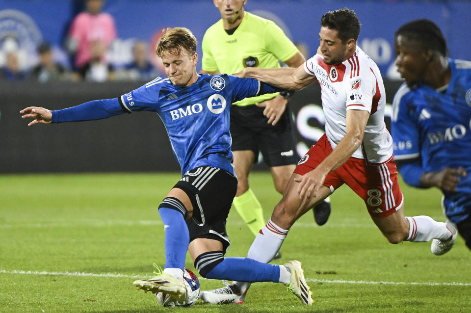 New England Revolution's Matthew Polster, right, defends against CF Montreal's Bryce Duke during the first half of an MLS soccer match Saturday, Aug. 26, 2023, in Montreal. (Graham Hughes/The Canadian Press via AP)