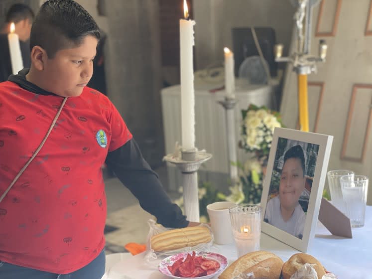 Bryan Osvaldo Hernandez, 10 (left) looks at altar placed for his brother and victim Brandon Giovanni Hernandez Tapia , 12 (in photo table). Brandon Giovannis family set up an altar in his honor at his family home in the Tlahuac neighborhood of Mexico City, to commemorate Brandon Giovannis passing on May 3. He was the youngest victim of the Metro accident on May 3 , Mexico City where 26 were killed.