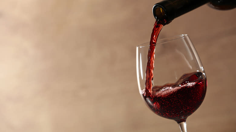 red wine pouring into glass