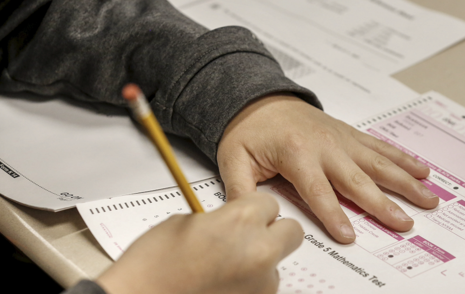 Hands of a student are shown with pencil and test booklet during New York State math test on May 2, 2017. (Photo by John Paraskevas/Newsday RM via Getty Images)
