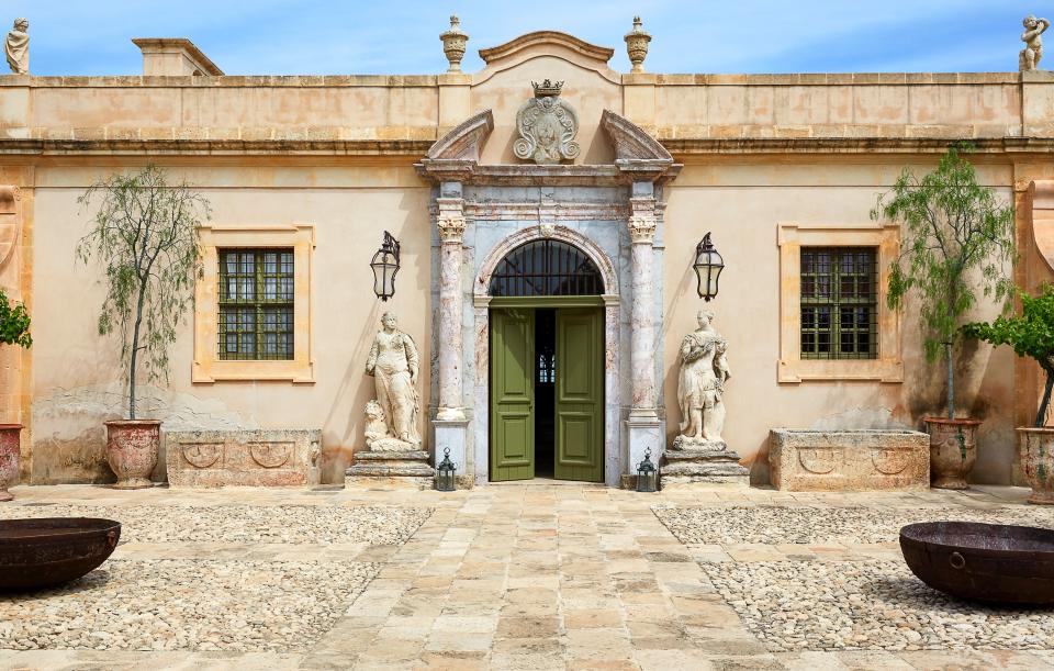 The entrance to the monastery turned country house is flanked by 17th-century stone figures.