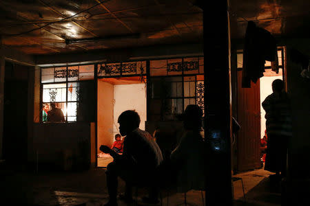 Refugees who fled fighting in neighbouring Myanmar sit in the house of a relative in the village of Baiyan near Nansan in the Yunnan province, China, March 11, 2017. REUTERS/Thomas Peter