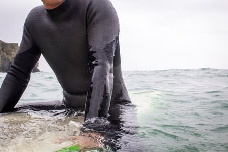 Tom Kay, founder of sustainable outdoor wear brand Finisterre, tests the prototype of what they believe is the world's first recyclable wetsuit in Cornwall