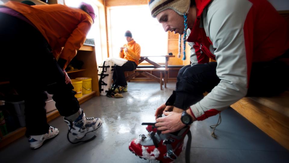 People adjusting ski boot