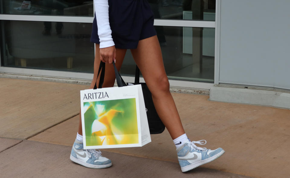 HALTON HILLS, ONT - JULY 1: A shopper carries an Aritzia bag at the Toronto Premium Outlets shopping mall on July 1, 2022, in Halton Hills, Ontario. (Photo by Gary Hershorn/Getty Images)
