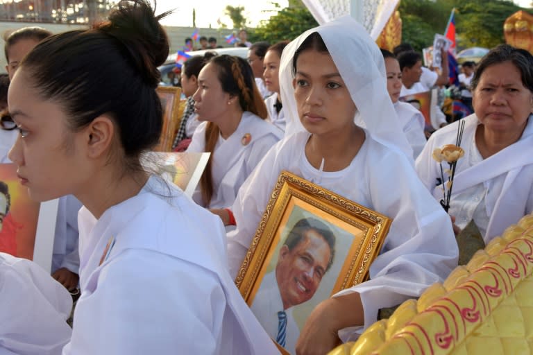 Bou Rachna (C), wife of Kem Ley, carries a portrait of her husband at his funeral on July 24, 2016