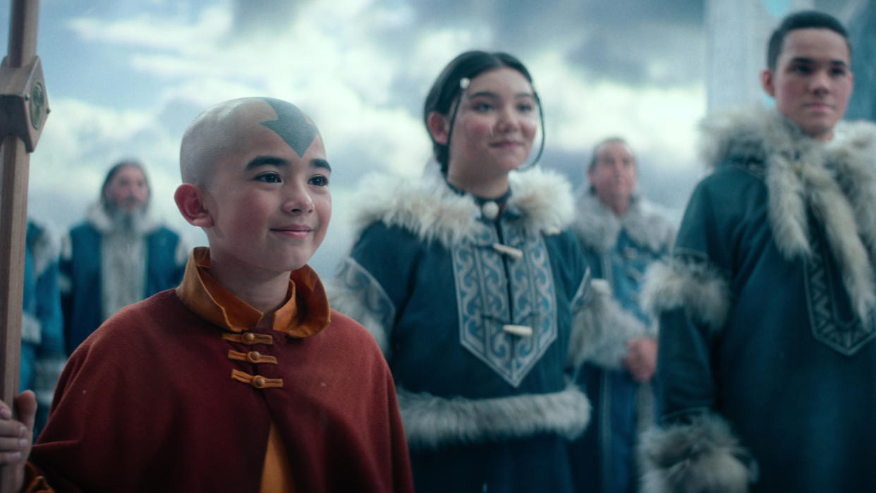  Aang smiles as Katara and Sokka stand in the background in Avatar: The Last Airbender. 