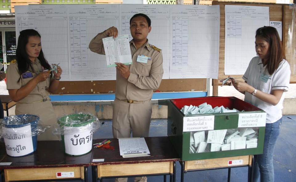 A Thai officer counts ballots after closing a polling station in Bangkok, Thailand, Sunday, March 24, 2019. Nearly five years after a coup, Thailand voted Sunday in a long-delayed election setting a military-backed party against the populist political force the generals overthrew. (AP Photo/Sakchai Lalit)