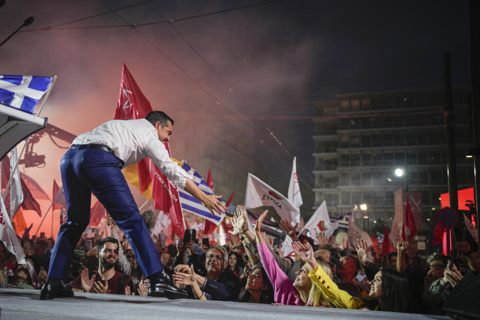 Leader of the main opposition Syriza party, Alexis Tsipras, shakes hands with his supporters during a pre-election rally, in Athens, on Thursday, May 18, 2023. Greeks go to the polls Sunday, May 21, in the first general election held since the country ended successive international bailout programs and strict surveillance period imposed by European leaders. Conservative Prime Minister Kyriakos Mitsotakis is seeking a second four-year term and is leading in opinions but may need a coalition partner to form the next government. (AP Photo/Thanassis Stavrakis)