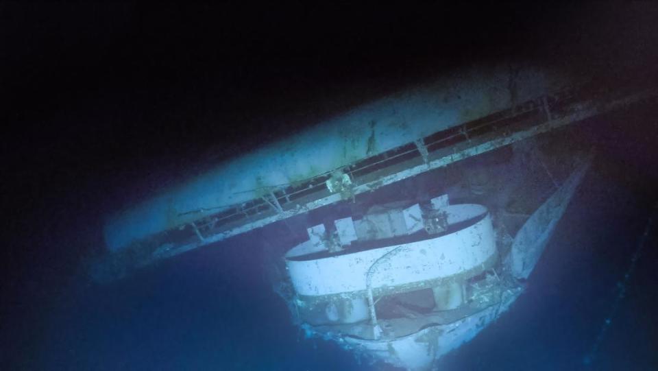 The strong starboard list of USS Yorktown on the seafloor can be seen in the flight deck, also collapsing towards the starboard side at the bow with an anti-aircraft gun tub below.  Photo captured by ROV Atalanta on September 9-10, 2023.  / Credit: OCEAN EXPLORATION TRUST, NOAA