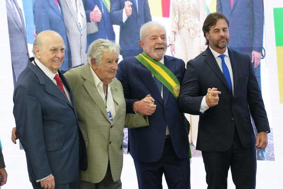 President Luiz Inacio Lula da Silva, second left, Uruguay's President Luis Alberto Lacalle Pou, right, former Uruguay President Jose 'Pepe' Mujica, second right, and former Uruguayan president Julio Maria Sanguinetti pose for a picture at the Planalto Palace in Brasilia, Brazil, Sunday, Jan. 1, 2023. (AP Photo/Eraldo Peres)