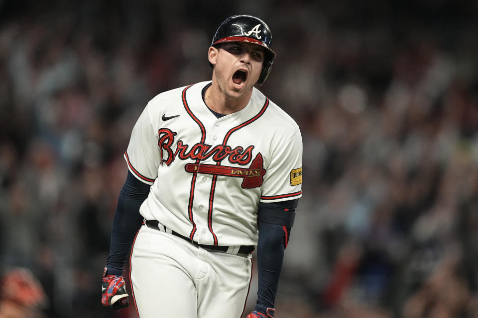 Atlanta Braves' Austin Riley (27) celebrates hitting a two run homer in the eighth inning of Game 2 of a baseball NL Division Series against the Philadelphia Phillies, Monday, Oct. 9, 2023, in Atlanta. (AP Photo/Brynn Anderson)