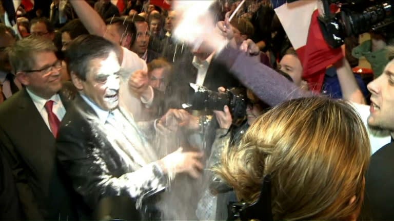 French presidential election candidate for the right-wing Les Republicains party Francois Fillon (C) reacts as a man throws flour at him on April 6, 2017 during a political rally in Strasbourg