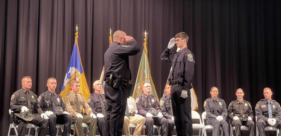 Cadet Gavin Pacewicz, center right, joins in a salute with Windber Borough Police Officer Cory Fairman just before Pacewicz receives his certificate.