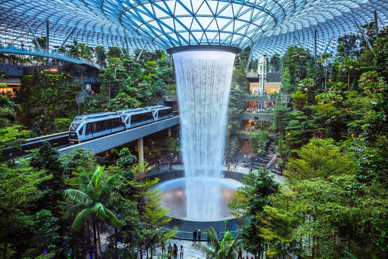 Singapore - July 24, 2019: The world's tallest indoor waterfall, named the Rain Vortex, which is surrounded by a terraced forest setting at Jewel Changi Airport, Singapore.