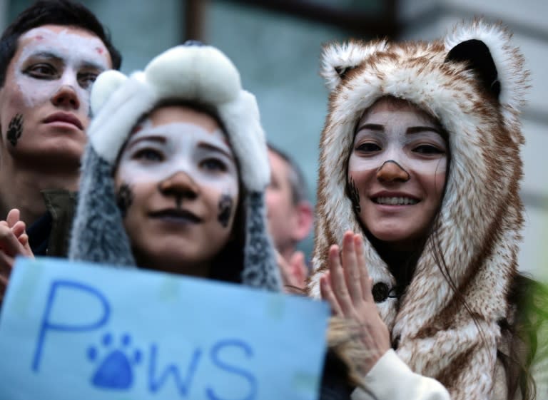 Climate change demonstrators listen to speeches at the end of a march to demand curbs to carbon pollution in London on November 29, 2015