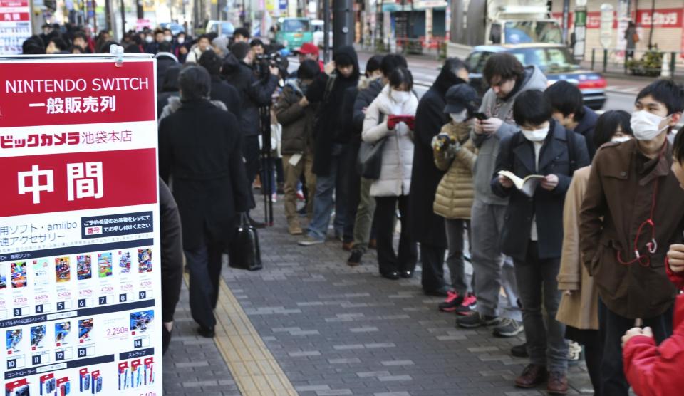 Shoppers line outside of retail store Bic Camera to buy Nintendo's newest computer game "Switch" in central Tokyo, Friday, March 3, 2017. (AP Photo/Koji Sasahara)