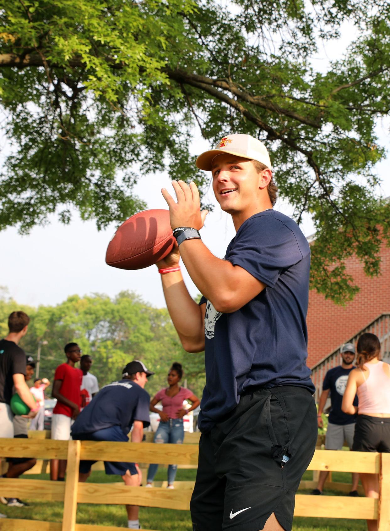 Iowa State quarterback Brock Purdy throws passes to kids during the Empowered Youth event at The Well Covenant Church in Des Moines on July 22, 2021.