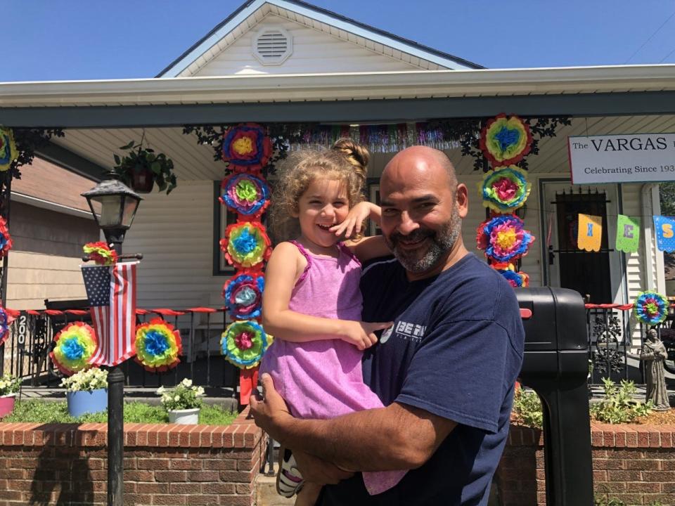 Part of the Vargas family, Olivia and Robbie Ramos, stand outside the home.