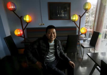 Tran Khanh Sinh, a gay person, poses for a photo in front of lamps in the colours of the gay rainbow flag at Comga restaurant where he is working in Hanoi, Vietnam, February 5, 2016. REUTERS/Kham