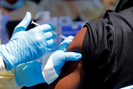 FILE PHOTO: A health worker injects a man with Ebola vaccine in Goma