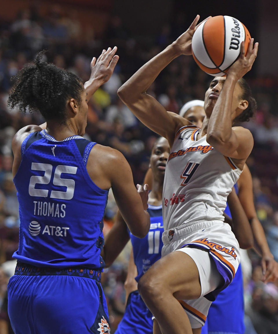 Phoenix Mercury guard Skylar Diggins-Smith (4) shoots after being fouled by Connecticut Sun forward DeWanna Bonner (24) during a WNBA basketball game Tuesday, Aug. 2, 2022, in Uncasville, Conn. (Sean D. Elliot/The Day via AP)