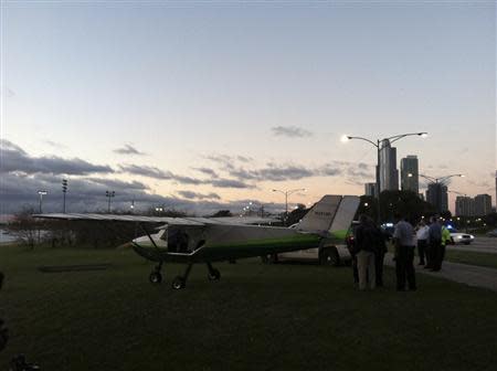 A small plane that was forced to make an emergency landing on Lake Shore Drive in Chicago is pictured in this handout photo taken September 22, 2013, courtesy of the Chicago Sun-Times. REUTERS/Chicago Sun-Times/Ashley Rezin/Handout via Reuters