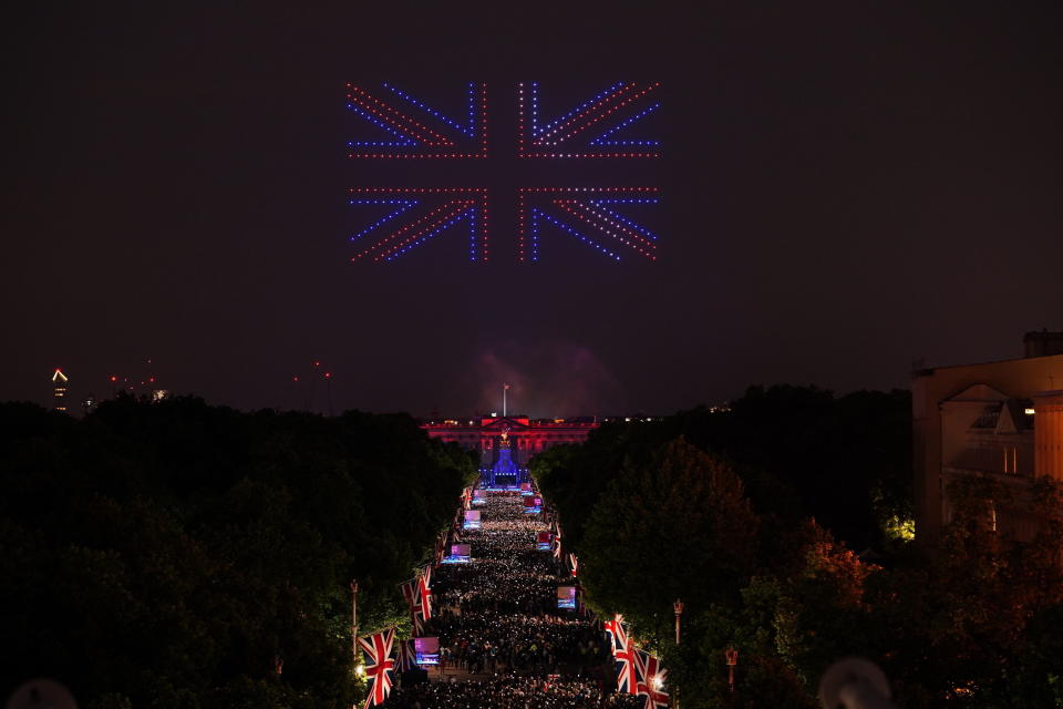 Drones make shapes above the Platinum Jubilee concert taking place in front of Buckingham Palace, London, Saturday June 4, 2022, on the third of four days of celebrations to mark the Platinum Jubilee. The events over a long holiday weekend in the U.K. are meant to celebrate Queen Elizabeth II’s 70 years of service. (Dominic Lipinski/PA via AP)