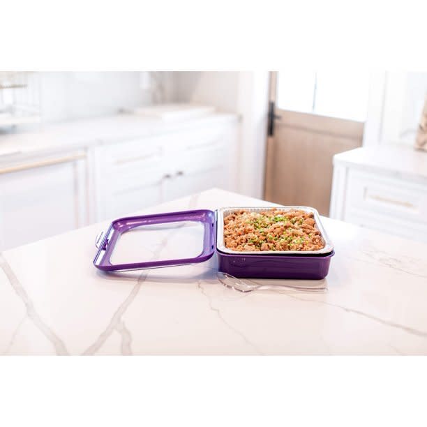 A purple foil pan carrier on a counter