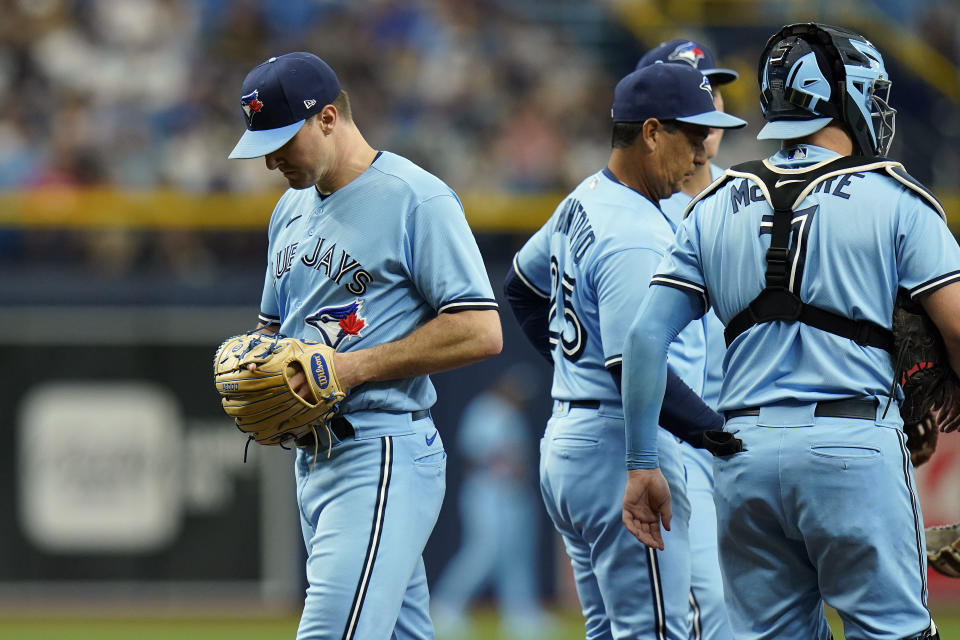 Toronto Blue Jays pitcher Ross Stripling, left, is relieved by manager Charlie Montoyo during the third inning of a baseball game against the Tampa Bay Rays Wednesday, Sept. 22, 2021, in St. Petersburg, Fla. (AP Photo/Chris O'Meara)