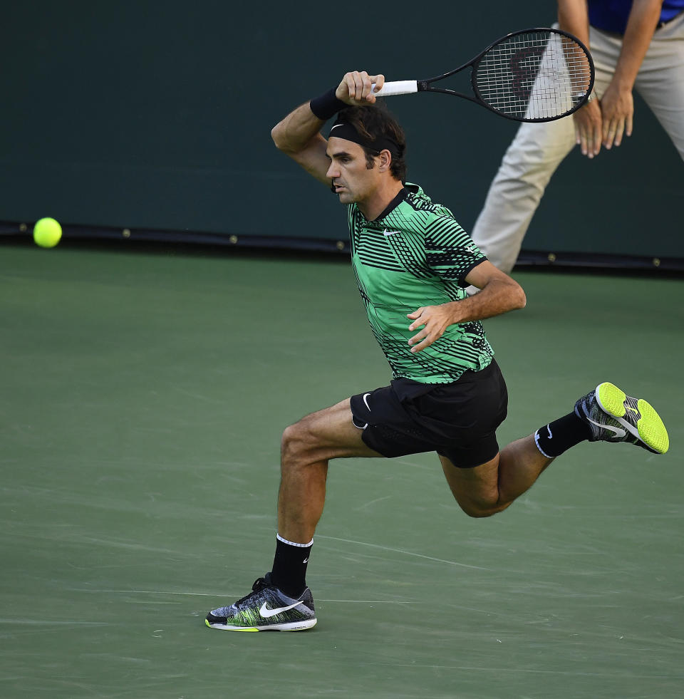 Roger Federer, of Switzerland, returns a shot against Rafael Nadal, of Spain, at the BNP Paribas Open tennis tournament, Wednesday, March 15, 2017, in Indian Wells, Calif. (AP Photo/Mark J. Terrill)