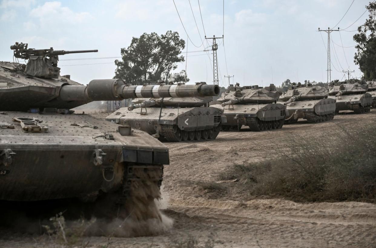 Israeli tanks gather near the border with the Gaza Strip on Oct. 13, 2023. <a href="https://www.gettyimages.com/detail/news-photo/graphic-content-israeli-army-merkava-battle-tanks-deploy-news-photo/1722767899" rel="nofollow noopener" target="_blank" data-ylk="slk:Aris Messinis/AFP via Getty Images;elm:context_link;itc:0;sec:content-canvas" class="link ">Aris Messinis/AFP via Getty Images</a>