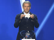 Juergen Klinsmann, former soccer player and soccer official, holds the lot of Spainduring the draw for the groups to qualify for the 2024 European soccer championship in Frankfurt, Germany, Sunday, Oct.9, 2022. (Arne Dedert/dpa via AP)