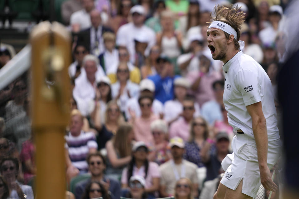 Kazakhstan's Alexander Bublik reacts after winning the 4th set against Russia's Andrey Rublev in a men's singles match on day seven of the Wimbledon tennis championships in London, Sunday, July 9, 2023. (AP Photo/Kirsty Wigglesworth)