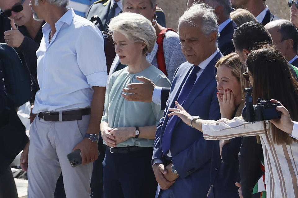 The President of the European Commission, Ursula von der Leyen, fifth from right front row, and the Italy's Premier Giorgia Meloni, third from right front row, visit the island of Lampedusa, in Italy, Sunday, Sept. 17, 2023. EU Commission President Ursula von der Leyen and Italian Premier Giorgia Meloni on Sunday toured a migrant center on Italy’s southernmost island of Lampedusa that was overwhelmed with nearly 7,000 arrivals in a 24-hour period this week. (Cecilia Fabiano/LaPresse via AP)