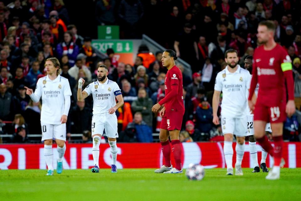 Liverpool’s Virgil van Dijk and Jordan Henderson react as Karim Benzema, second left, celebrates scoring Real Madrid’s fourth goal (PA Wire)