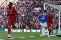 Liverpool's Divock Origi, left, celebrates after scoring his sides second goal during the English Premier League soccer match between Liverpool and Everton at Anfield stadium in Liverpool, England, Sunday, April 24, 2022. (AP Photo/Jon Super)