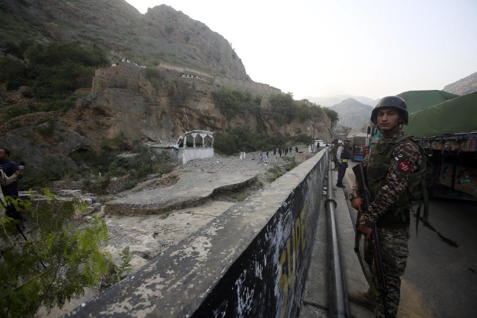 Security personnel stand guard at the site of a suicide bomber attack inside a roadside mosque in the Khyber district in Khyber Pakhtunkhwa province, of Pakistan, Tuesday, July 25, 2023. A suicide bomber blew himself up inside a roadside mosque when a police officer tried to arrest him after a chase in northwestern Pakistan near the Afghan border on Tuesday, killing the officer, police said. (AP Photo/Muhammad Sajjad)