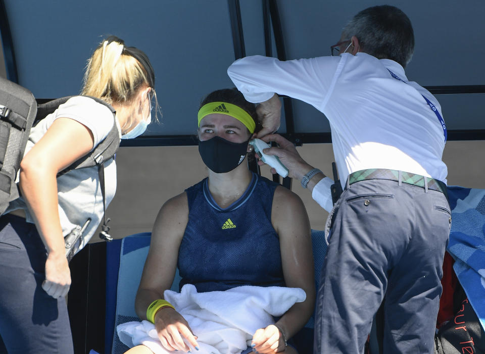 Karolina Muchova of the Czech Republic receives medical treatment during her quarterfinal against Australia's Ash Barty at the Australian Open tennis championship in Melbourne, Australia, Wednesday, Feb. 17, 2021.(AP Photo/Andy Brownbill)