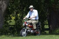 <p>File this under things we never thought we'd see: Prince Philip riding a mini motorcycle. Nonetheless, the Prince enjoyed a ride on a sunny day in Windsor in 2002.</p>