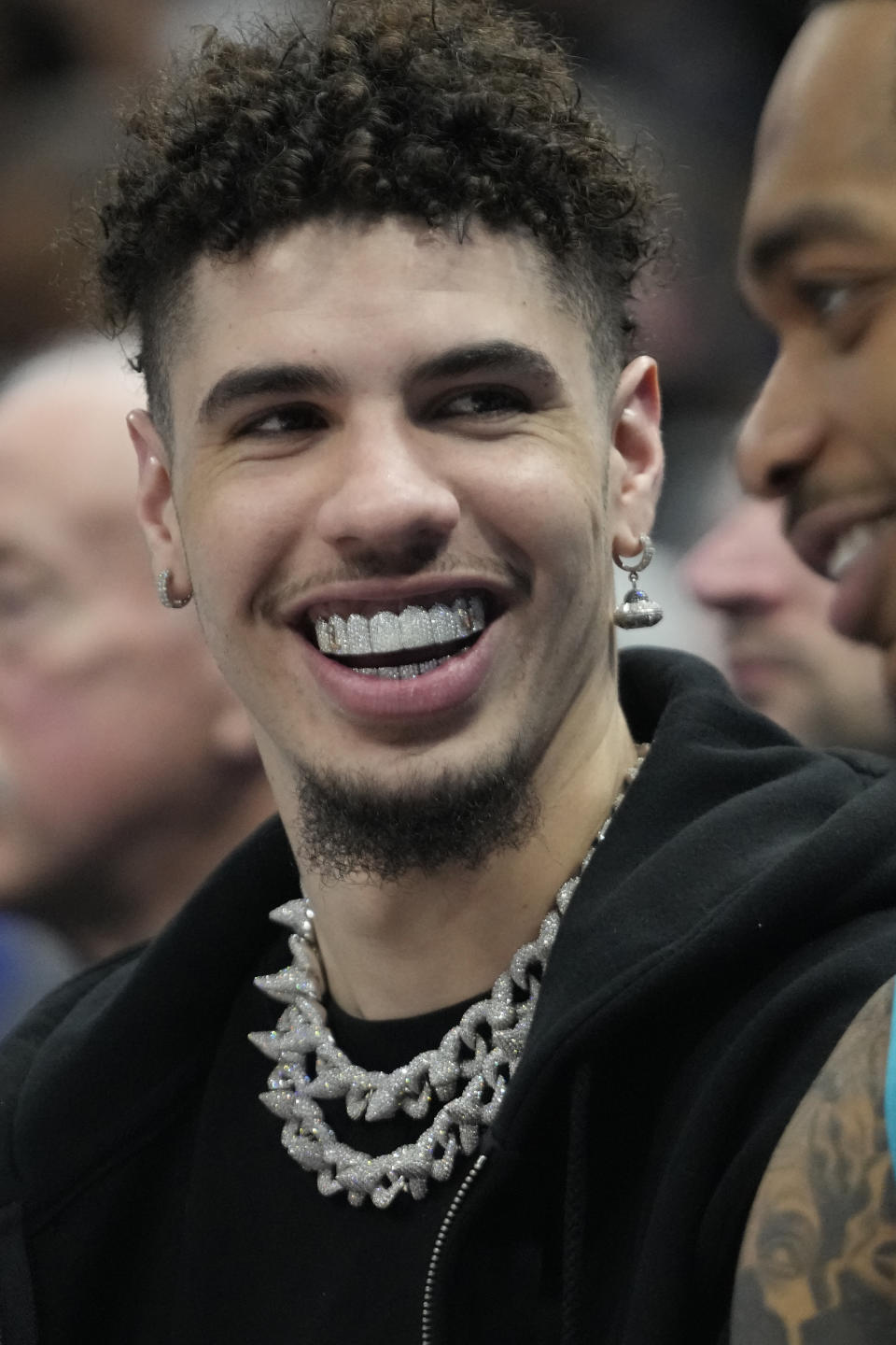 Charlotte Hornets guard LaMelo Ball sits on the bench during the first half of an NBA basketball game against the Utah Jazz, Monday, Jan. 23, 2023, in Salt Lake City. (AP Photo/Rick Bowmer)