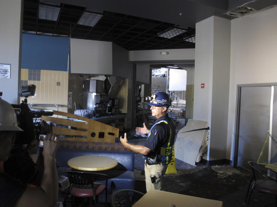 University of Nevada, Reno Police Chief Todd Renwick describes the damage inside a school dormitory from a July 5 natural gas explosion, Thursday, July 11, 2019, in Reno, Nev., during a tour that gave members of their media their first look at the interior. Structural engineers with experience responding to earthquakes and natural disasters are helping with efforts to rebuild it over the next year or so. Eight people suffered minor injuries in the blast at the mostly empty Argenta Hall. (AP Photo/Scott Sonner)