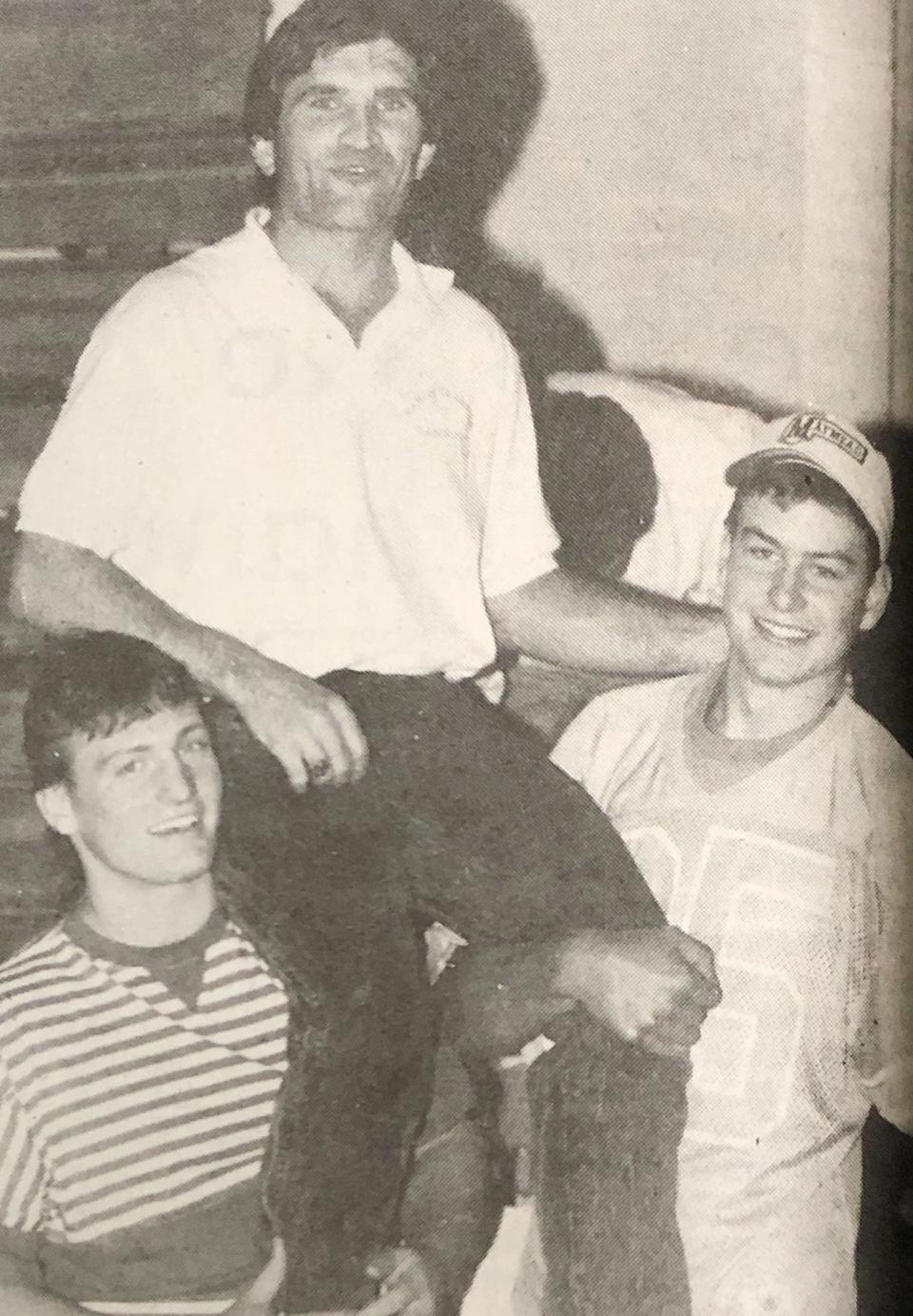 Hamlin head coach Arlin Likness is lifted by players Scott Sauder (left) and Ron Holliday during a welcome home celebration for Hamlin's state Class 11B state championship football team in 1989. It was the first state title for Hamlin, which repeated in 1990 and 1991.