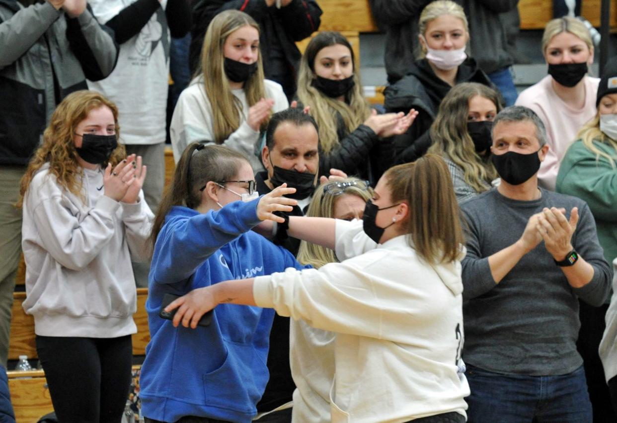 Priscilla Bonica left, hugs her former basketball coach, Allie Scarpa, right, during the Bigger than Basketball fundraiser for Priscilla at Quincy High School, Saturday, Feb. 6, 2022. Priscilla, a 2021 Quincy high graduate and who played several sports while a student, died of brain cancer on Saturday morning, June 17.