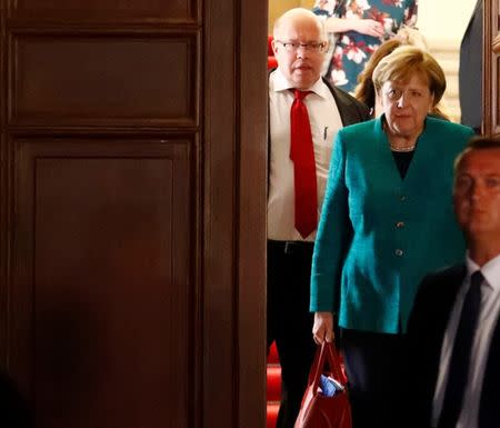 Leader of the Christian Democratic Union of Germany (CDU) Angela Merkel leaves the German Parliamentary Society offices after the exploratory talks with leaders of the German Green Party about forming a new coalition government held by CDU/CSU in Berlin, Germany, October 18, 2017. REUTERS/Fabrizio Bensch