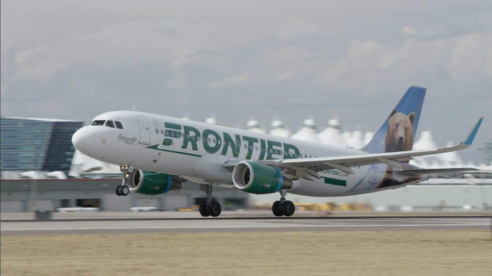 A Frontier Airlines jet is shown at Denver International Airport.